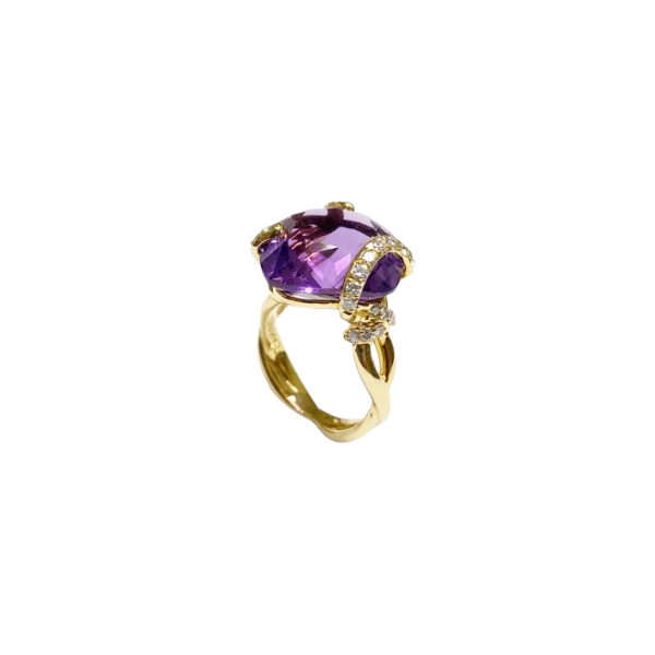 Gold ring with a large purple gemstone on a white background