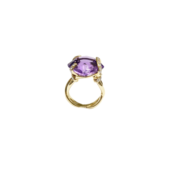 Gold ring with a purple gemstone on a white background