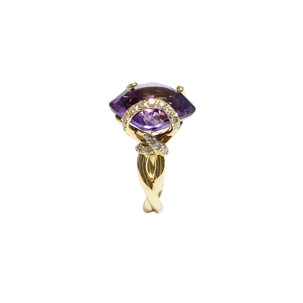 Gold ring with purple gemstone on a white background