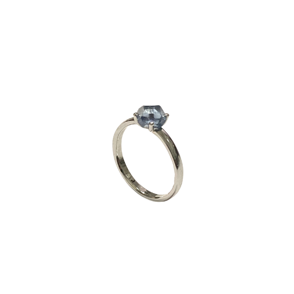 Platinum ring with a blue gemstone on a white background