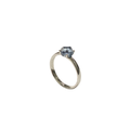 Platinum ring with a blue gemstone on a white background