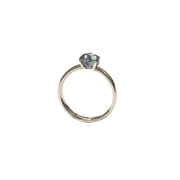 Platinum ring with a blue gemstone on a white background