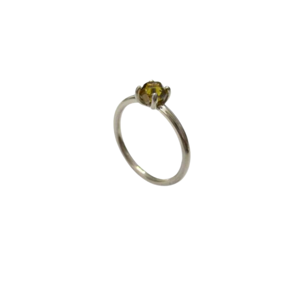 Silver ring with a yellow gemstone on a white background