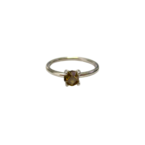 Silver ring with a brown gemstone on a white background